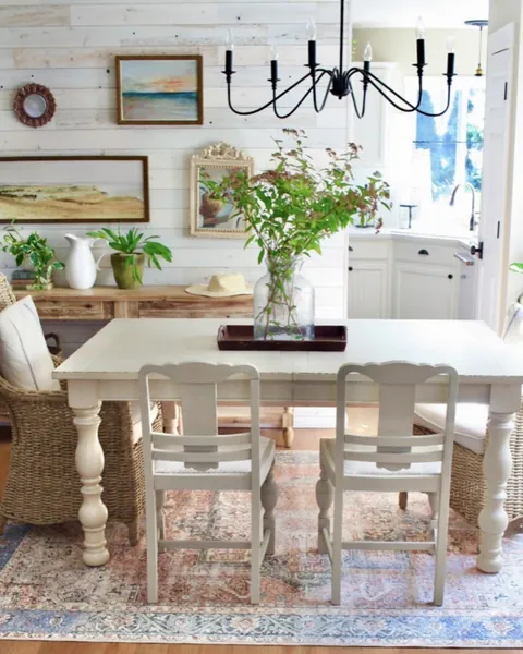 Dining room with shiplap wall and cat on floor